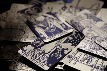 Mystical atmosphere captured through a detailed tarot card arrangement on a textured surface. Rich symbolism and traditional esoteric themes evoke intuition, divination, and spiritual insight. Ideal f
