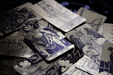 Mystical atmosphere captured through a detailed tarot card arrangement on a textured surface. Rich symbolism and traditional esoteric themes evoke intuition, divination, and spiritual insight. Ideal f