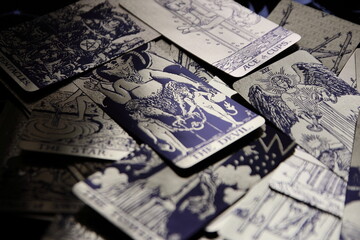 Mystical atmosphere captured through a detailed tarot card arrangement on a textured surface. Rich symbolism and traditional esoteric themes evoke intuition, divination, and spiritual insight. Ideal f