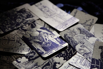 Mystical atmosphere captured through a detailed tarot card arrangement on a textured surface. Rich symbolism and traditional esoteric themes evoke intuition, divination, and spiritual insight. Ideal f