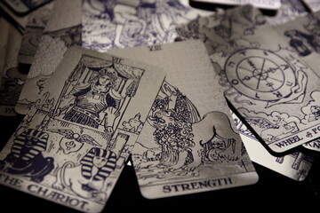Mystical atmosphere captured through a detailed tarot card arrangement on a textured surface. Rich symbolism and traditional esoteric themes evoke intuition, divination, and spiritual insight. Ideal f