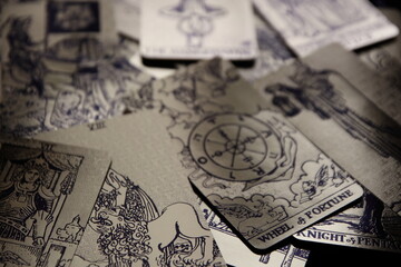 Mystical atmosphere captured through a detailed tarot card arrangement on a textured surface. Rich symbolism and traditional esoteric themes evoke intuition, divination, and spiritual insight. Ideal f