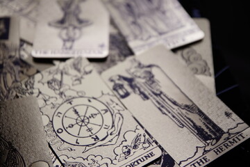 Mystical atmosphere captured through a detailed tarot card arrangement on a textured surface. Rich symbolism and traditional esoteric themes evoke intuition, divination, and spiritual insight. Ideal f