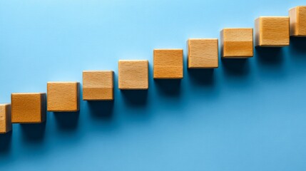 The wooden blocks are arranged in the form of stairs on the blue ground, the steps to business success, the concept of success