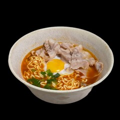 instant noodle with pork and egg in bowl on black background