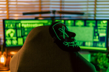In a dimly lit cyber lair, a glowing hacker mask watches over a desk as encrypted code streams...