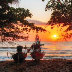 2 boats on the beach at sunrise, Nakhon Si Thammarat Province, Thailand