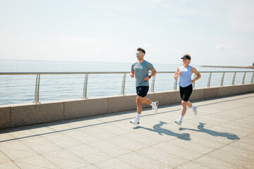 Jogging along the serene waterfront path under a bright summer sky