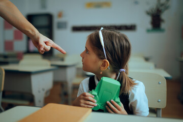 Teacher Scolding Student For Playing with a Game Toy. Little girl hiding a retro console not...