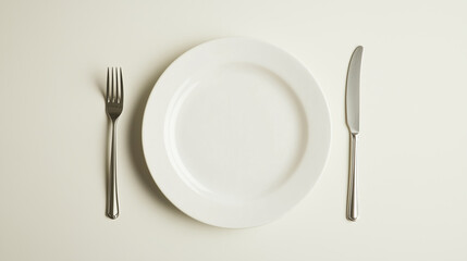 An empty white plate with a fork and knife on a neutral background. perfect for concepts of food, dining, diet, or minimalism