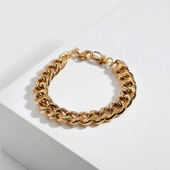 Obraz premium A close up studio shot of a shiny gold chain link bracelet on a white surface with a subtle shadow