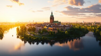Obraz premium Scenic aerial view of a historic city with a prominent clock tower surrounded by green parks du sunset