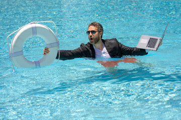 Saving money. Businessman with save rescue buoy and laptop. Help business man. Credit business....