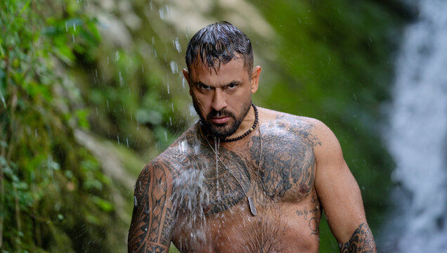 Power man. Muscular body. Healthy muscular male body under waterfall. Strong man splashing in nature. Fit and sexy male torso. Athletic body. Man beauty. Summer health. Healthy lifestyle.
