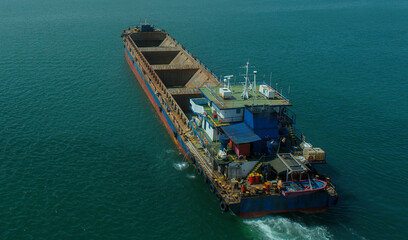 Marine Cargo Barge in Transit with Tugboat Support
