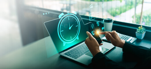 Time management concept with businessperson using smartphone and laptop, featuring digital alarm...