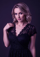 Fototapeta premium A woman in a black lace dress is posing for a photo. The photo is in a purple and blue color scheme, giving it a moody and seductive feel