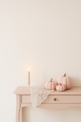 coquette halloween setup with pumpkins, candles and lace on vertical console table, soft pastel styling with open area above for text or promotional layout, concept of visual branding, seasonal editor