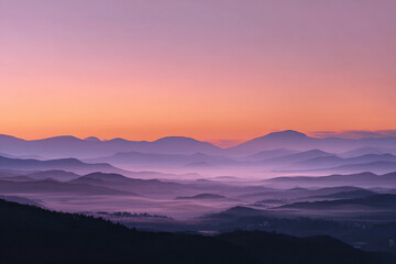 Layers of Mountains in a Colorful Sunrise Mist