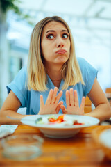 Woman Doing Intermittent Fasting Spiking Meal in a restaurant. Lady having no appetite refusing...