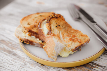 Cheese sandwich and grilled ham on a table in cafe.