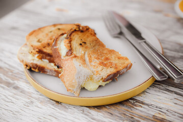 Cheese sandwich and grilled ham on a table in cafe.