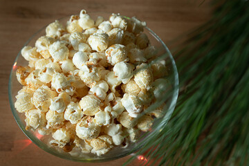 Freshly popped popcorn in a festive setting with glowing lights