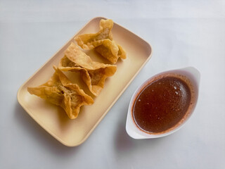 Batagor isolated on white Background, made from fish or chicken dumpling, tofu, tapioca flour served with peanut sauce. Indonesian food
