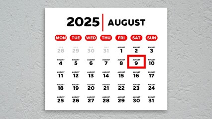 The date August 9th marked with a red cursor on the wall calendar 2025