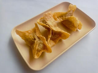 Batagor isolated on white Background, made from fish or chicken dumpling, tofu, tapioca flour served with peanut sauce. Indonesian food