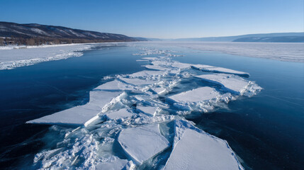 Icebergs float on serene blue lake surrounded by mountains under clear sky, showcasing beauty of nature texture and tranquility