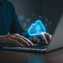 Person uploading data to the cloud on a laptop