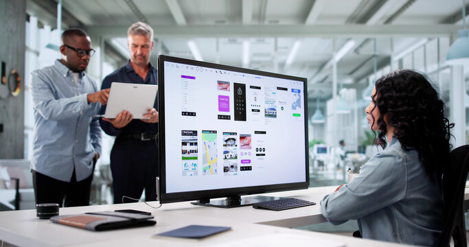 Multiracial Team Of UI Designers Enhancing Mobile App