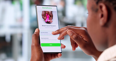 Young Woman Using Smartphone To Donate Money