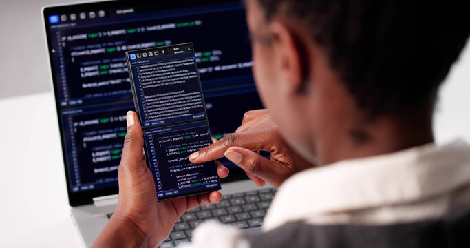 Young African American Woman Writing Code On Laptop