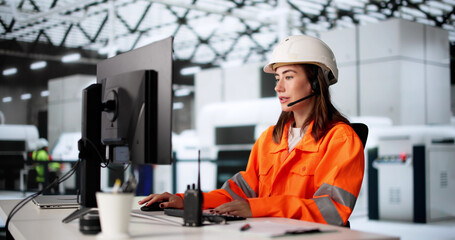 Female Worker Using Computer In Industrial Production Automation System