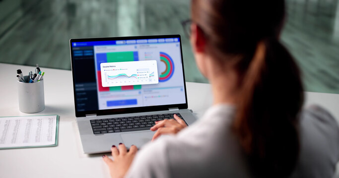 Analyzing Market Trends: Businesswoman Evaluates Data