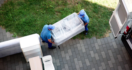 Hardworking Furniture Mover Transporting Sofa
