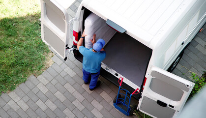 Hispanic Mover Unloading Mattress From Delivery Truck