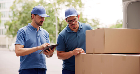 Hispanic Mover Unloading Boxes From Delivery Truck