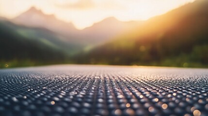 Fototapeta premium Textured Horizon: A textured, glistening surface contrasts with a serene mountain landscape at dawn, evoking a sense of calm and vastness.