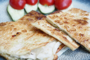 Veggie flatbread with tomatoes on a plate