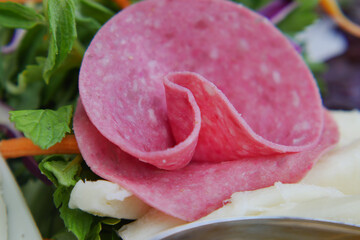 Delicious slices of cold cuts displayed on fresh greens