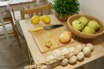 Lemon, pear, and garlic preparation on kitchen table