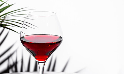 Explore non-alcoholic red wine in a stylish glass against a minimalist backdrop for a sophisticated...