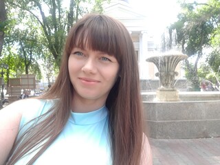 Stock photo of a woman taking a selfie near a beautiful fountain