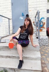 
Stock photo of a woman holding a table tennis racket in her hands, active outdoor recreation

