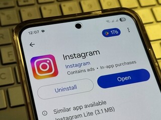 Instagram App uninstall or open from Play store on Android smartphone with screen Dynamic LTPO AMOLED on keyboard laptop. Pamekasan, Indonesia - Jul 20, 2025.