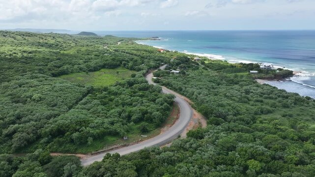 Aerial Drone footage of coastal road next to the ocean. Costanera in Nicaragua