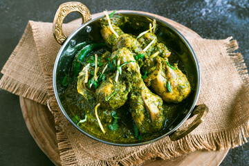 North Indian-style palak chicken – spinach-based chicken curry, saag chicken, green Indian gravy, healthy non-vegetarian dish, traditional Indian chicken curry, top view
